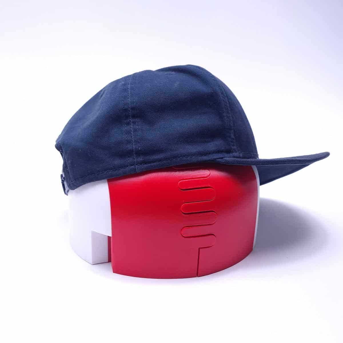 A creased 9FIFTY baseball cap on the Capfixer frame