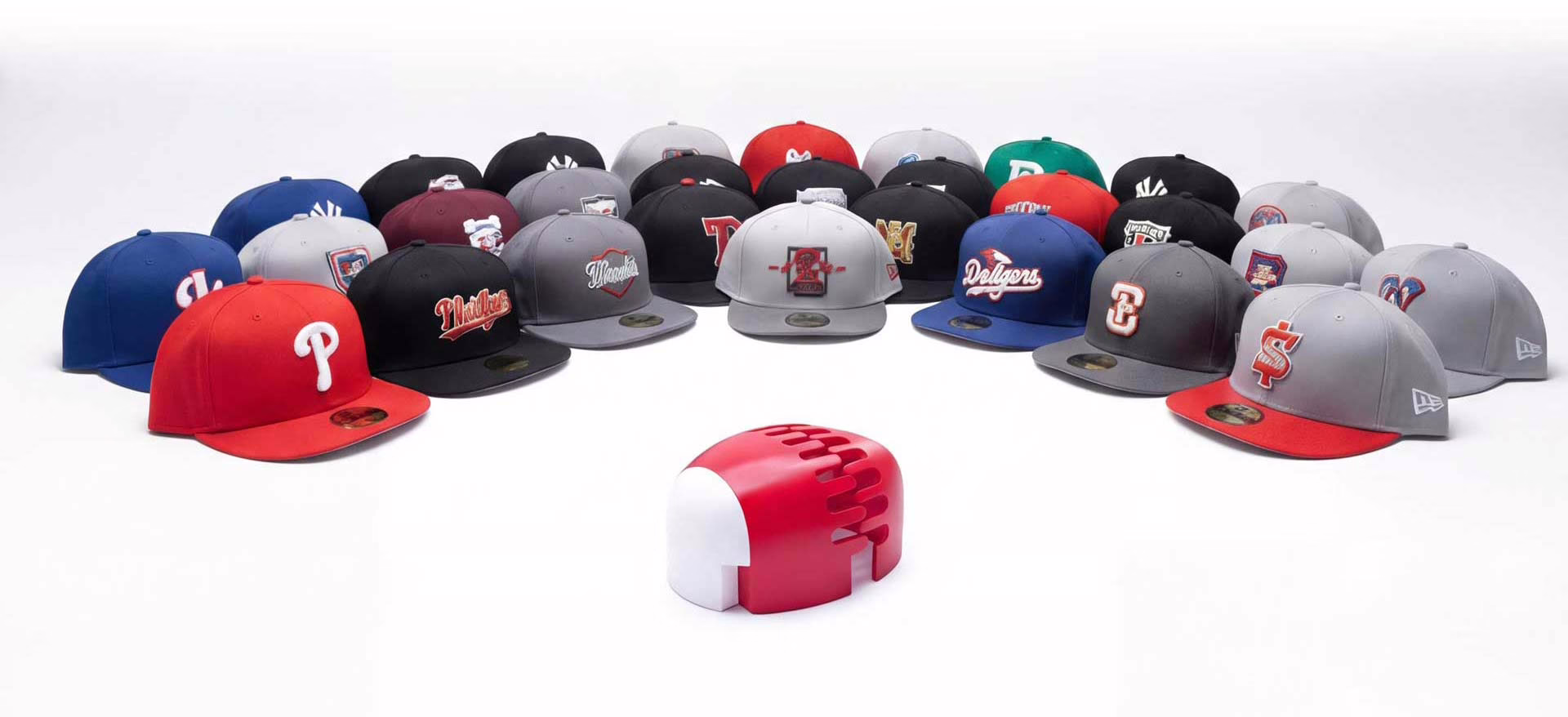 Professional CapShaper machine in the center with a row of baseball caps waiting to be steamed and reshaped mobil hero pic